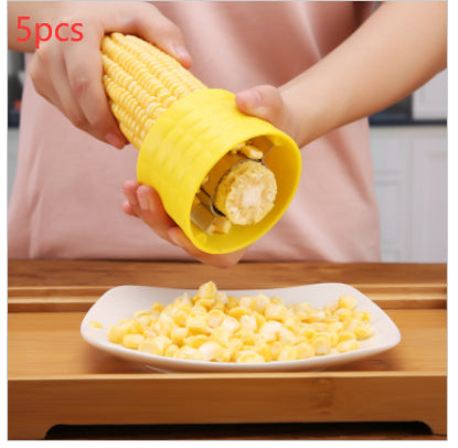 Corn kernel remover in use on cob